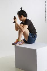 Sportswear Fighting with gun Woman Asian Sitting poses - ALL Average medium black Sitting poses - simple Standard Photoshoot Academic